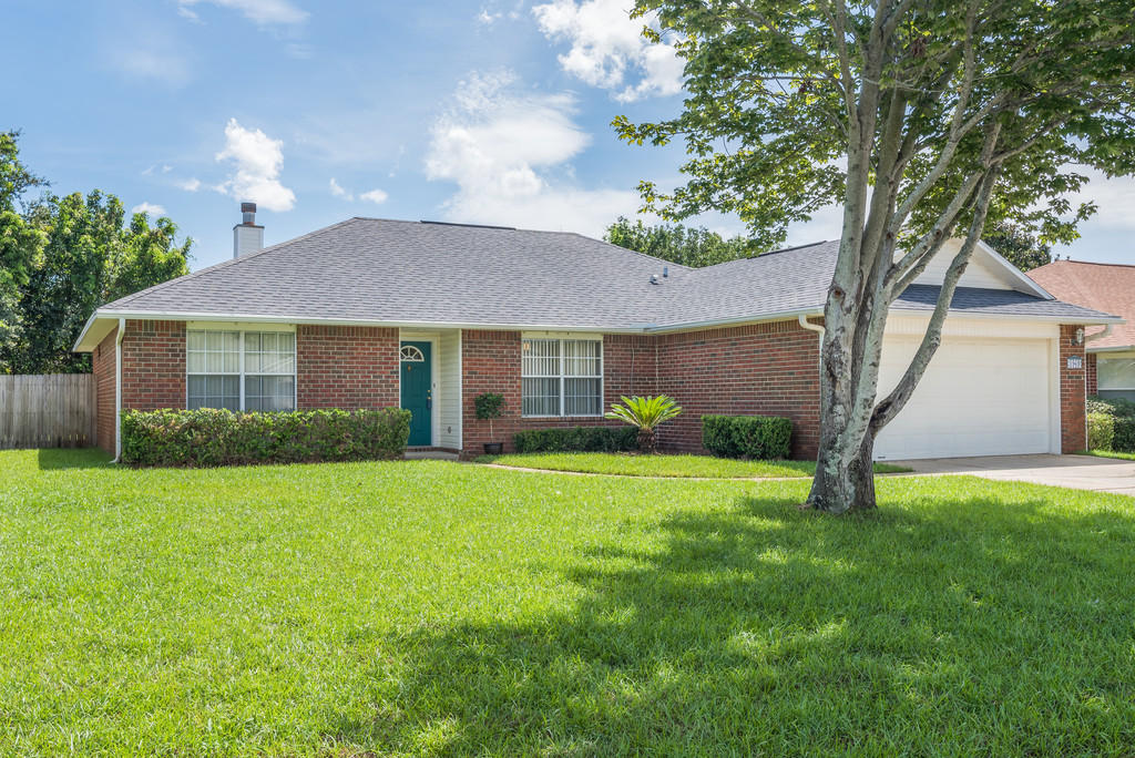 1969 Jessica Way Navarre, FL 32566 - Photo 2 of 17 a front view of a house with garden