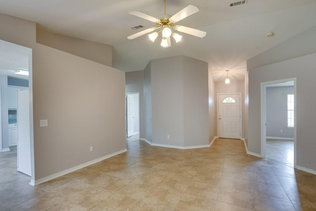 1969 Jessica Way Navarre, FL 32566 - Photo 5 of 17 an empty room with fan and entrance