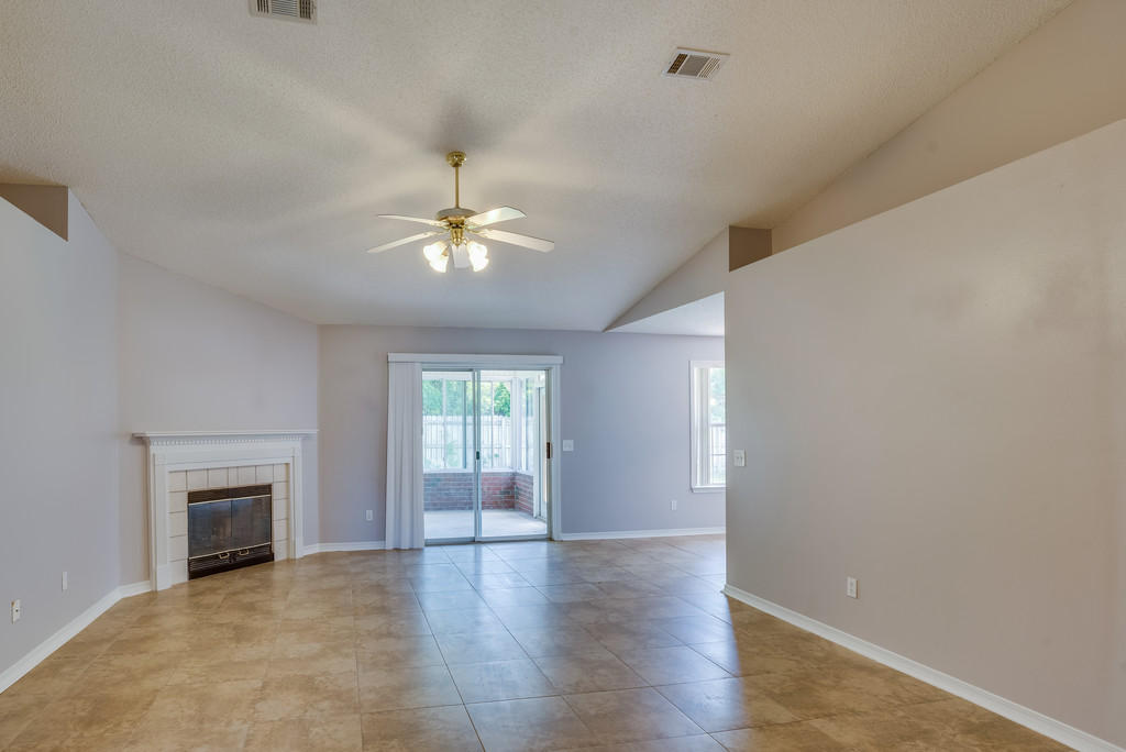 1969 Jessica Way Navarre, FL 32566 - Photo 6 of 17 wooden floor in an empty room with a window