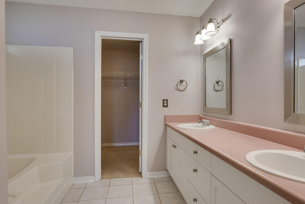 1969 Jessica Way Navarre, FL 32566 - Photo 9 of 17 a spacious bathroom with a granite countertop sink a mirror and a bathtub