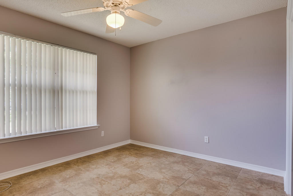 1969 Jessica Way Navarre, FL 32566 - Photo 10 of 17 an empty room with windows and fan