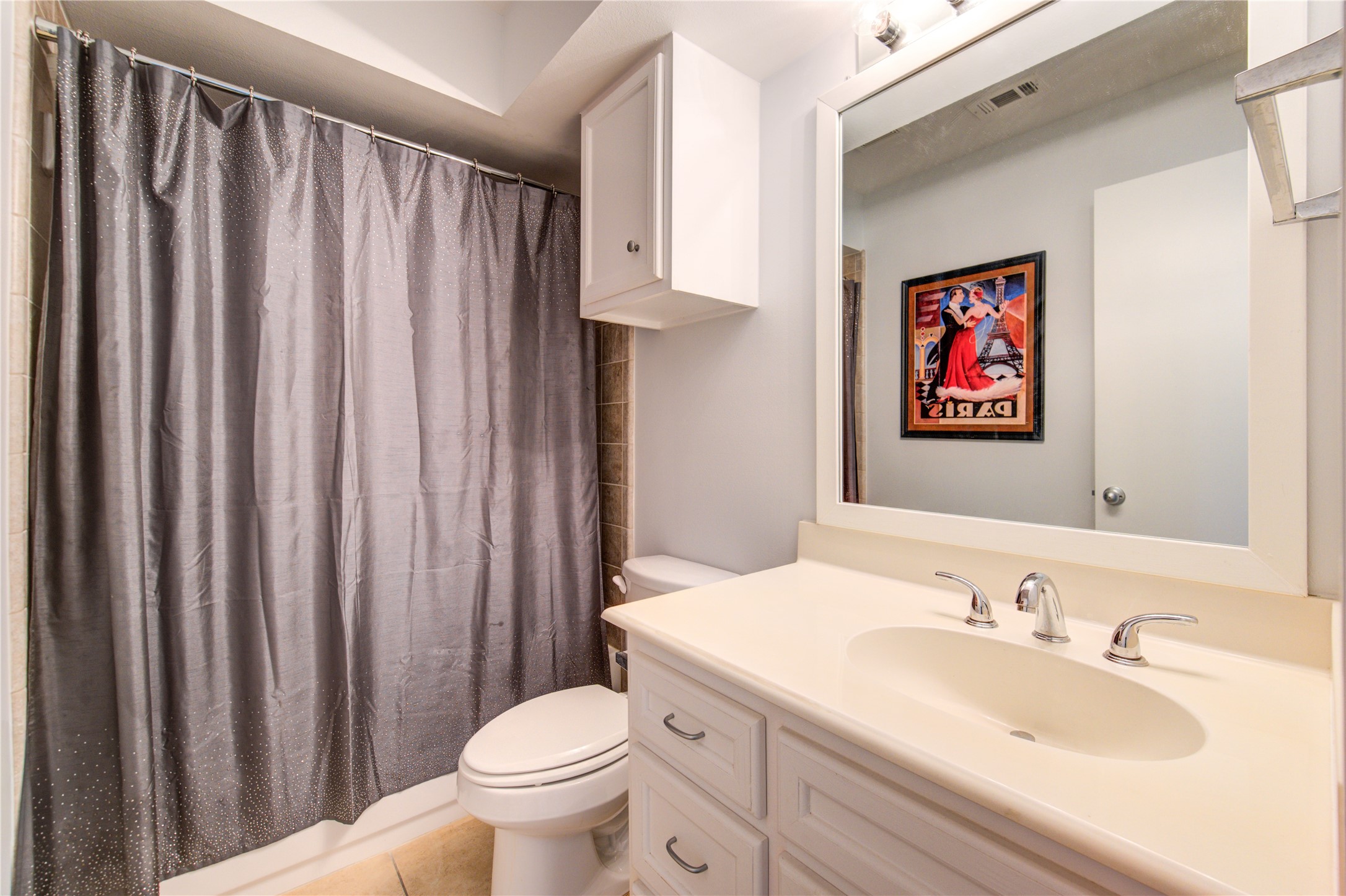 650 Westcross Street, Unit 83 Houston, TX 77018 - Photo 11 of 48 a bathroom with a sink a toilet and shower curtain