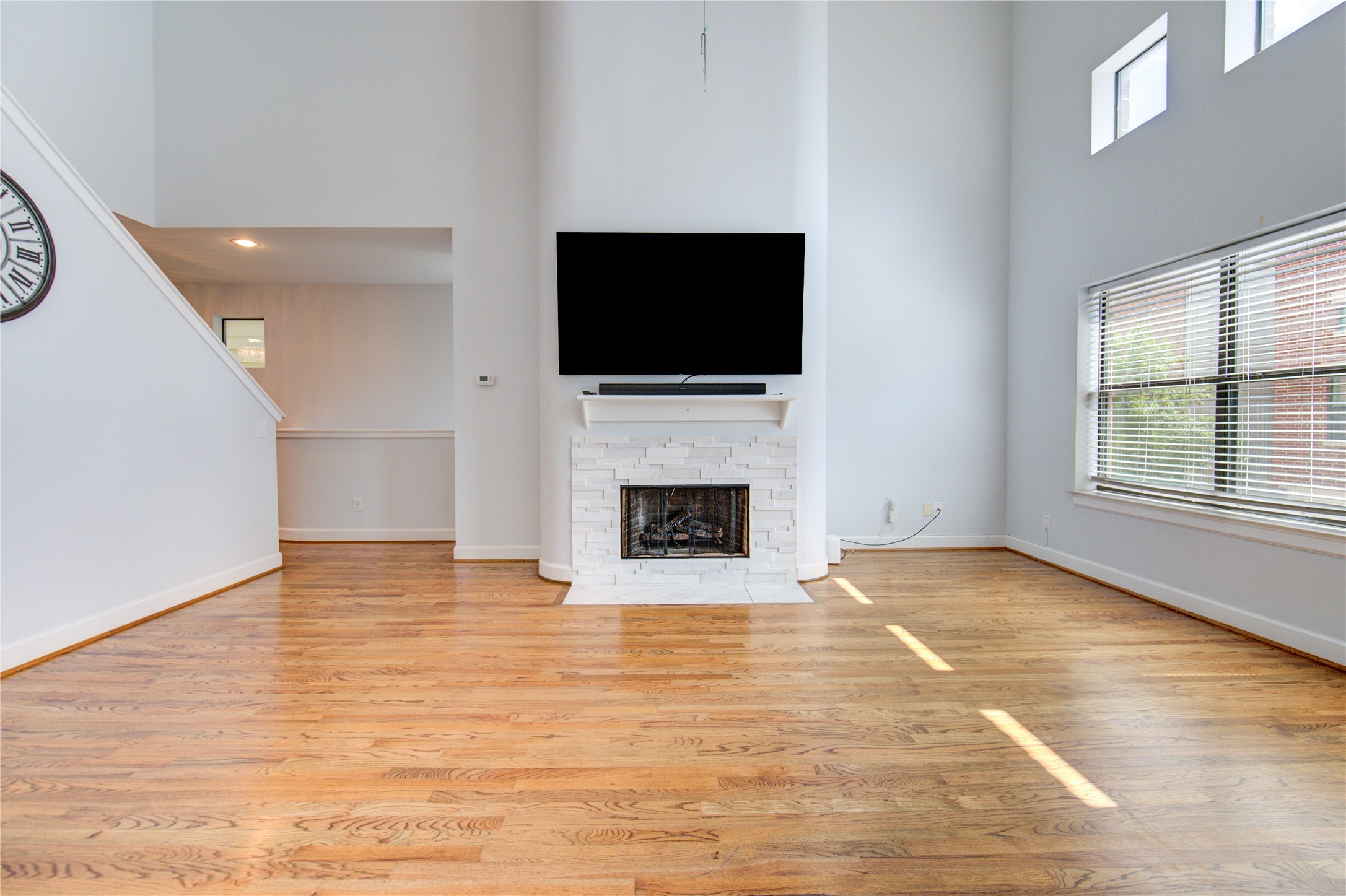 650 Westcross Street, Unit 83 Houston, TX 77018 - Photo 18 of 48 a view of a livingroom with a fireplace a flat screen tv and staircase