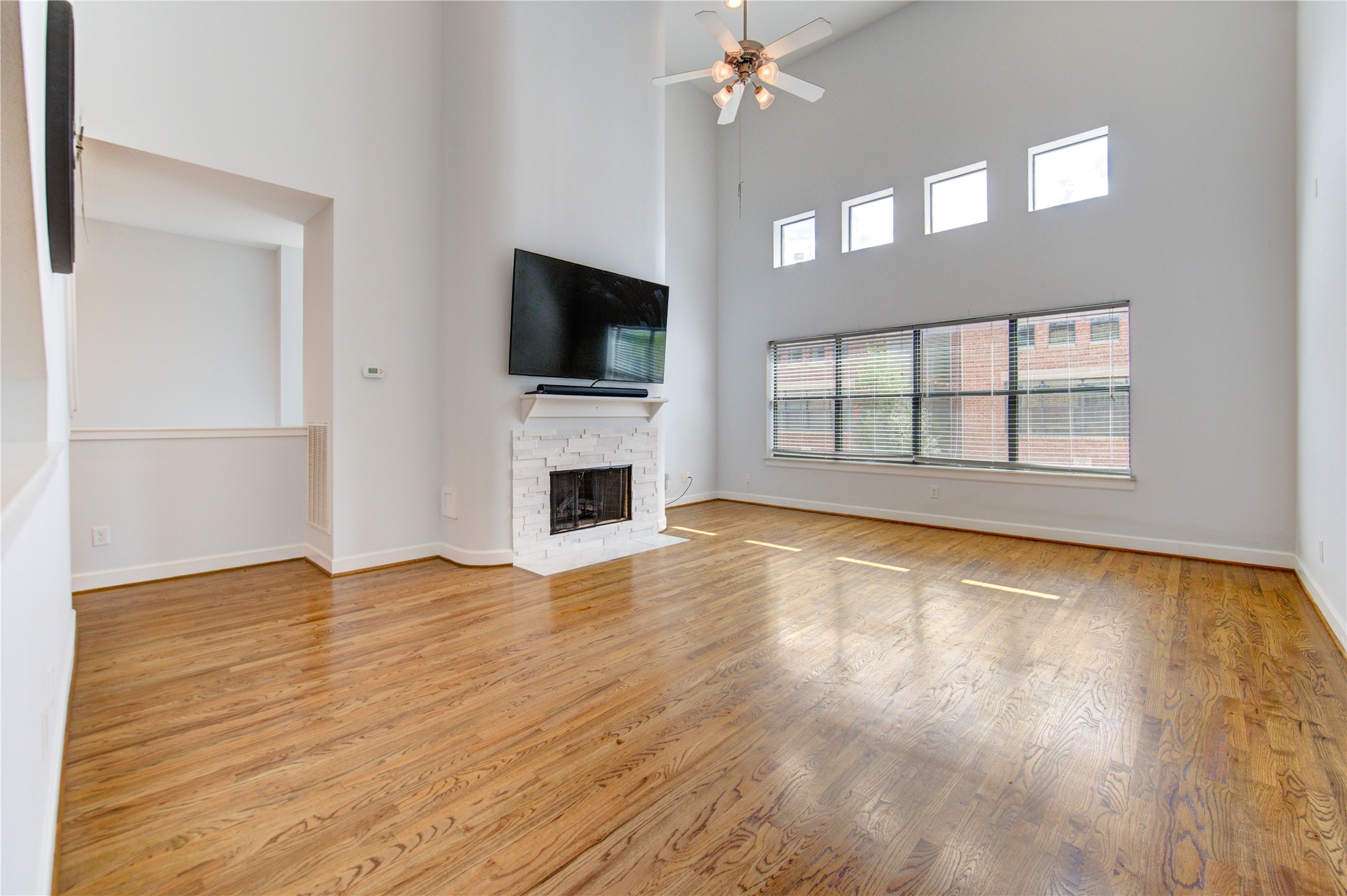 650 Westcross Street, Unit 83 Houston, TX 77018 - Photo 19 of 48 a view of empty room with wooden floor and fan