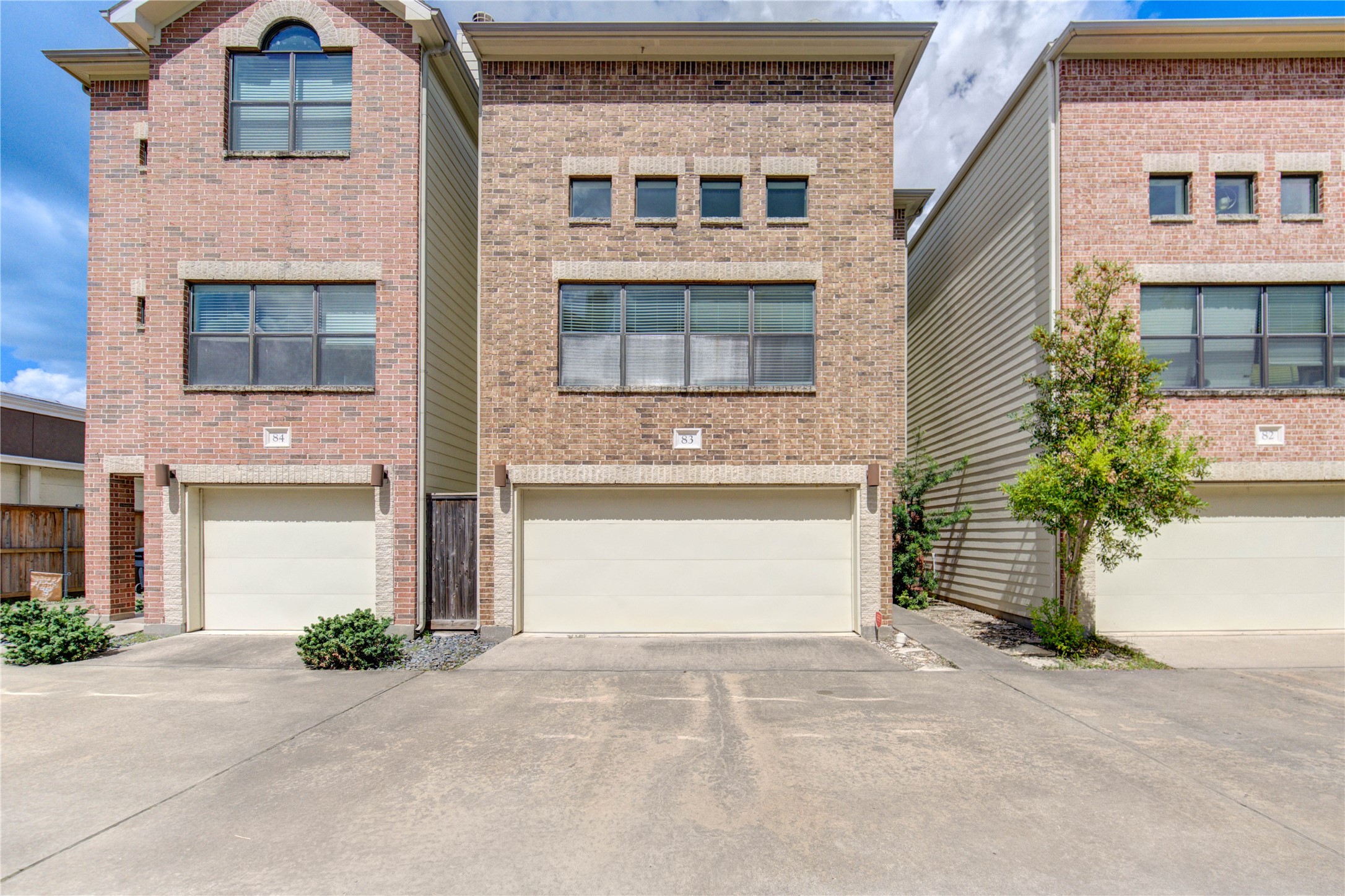 650 Westcross Street, Unit 83 Houston, TX 77018 - Photo 2 of 48 a front view of a house with a yard and garage