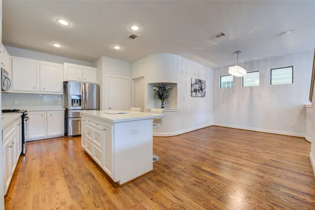 a kitchen with a stove a sink and a microwave