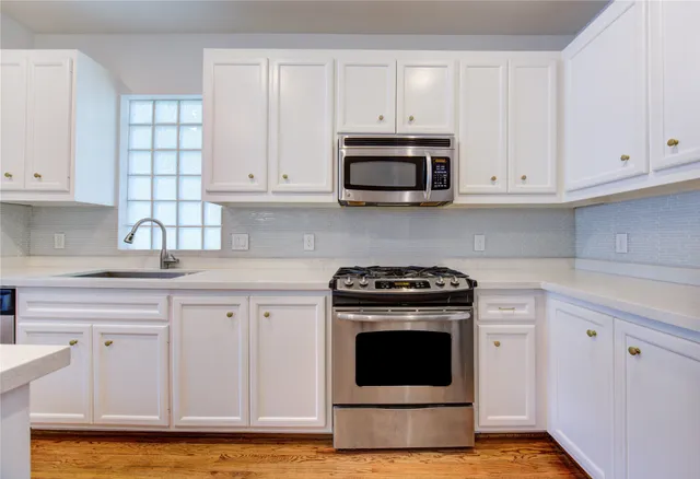 a kitchen with a sink and a stove top oven