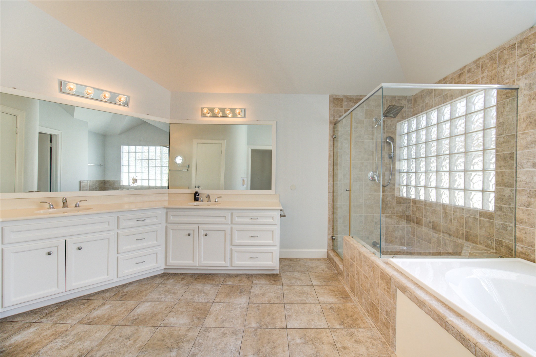 650 Westcross Street, Unit 83 Houston, TX 77018 - Photo 35 of 48 a spacious bathroom with a granite countertop sink mirror and a bathtub