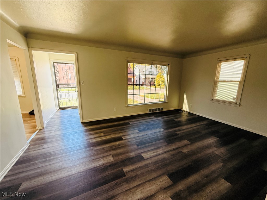 5239 Arch Street Maple Heights, OH 44137 - Photo 5 of 25 Spare room featuring dark wood-type flooring and baseboards