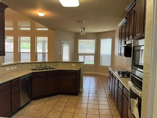 a kitchen with a sink and a stove top oven
