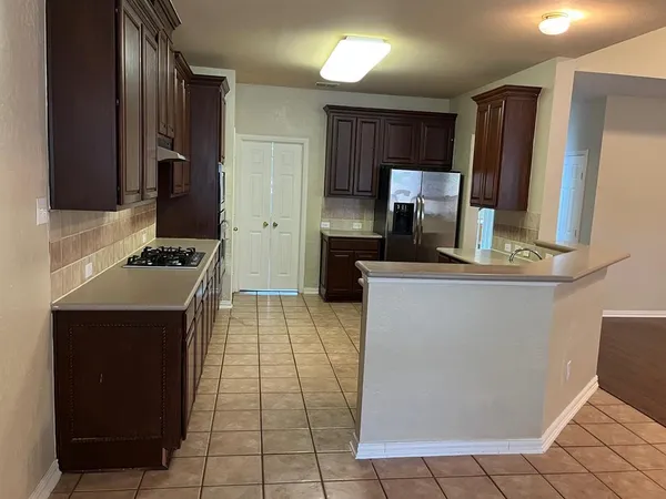 a kitchen with stainless steel appliances a sink stove and refrigerator