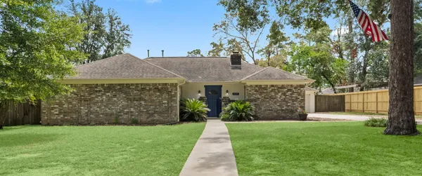 a front view of house with a garden
