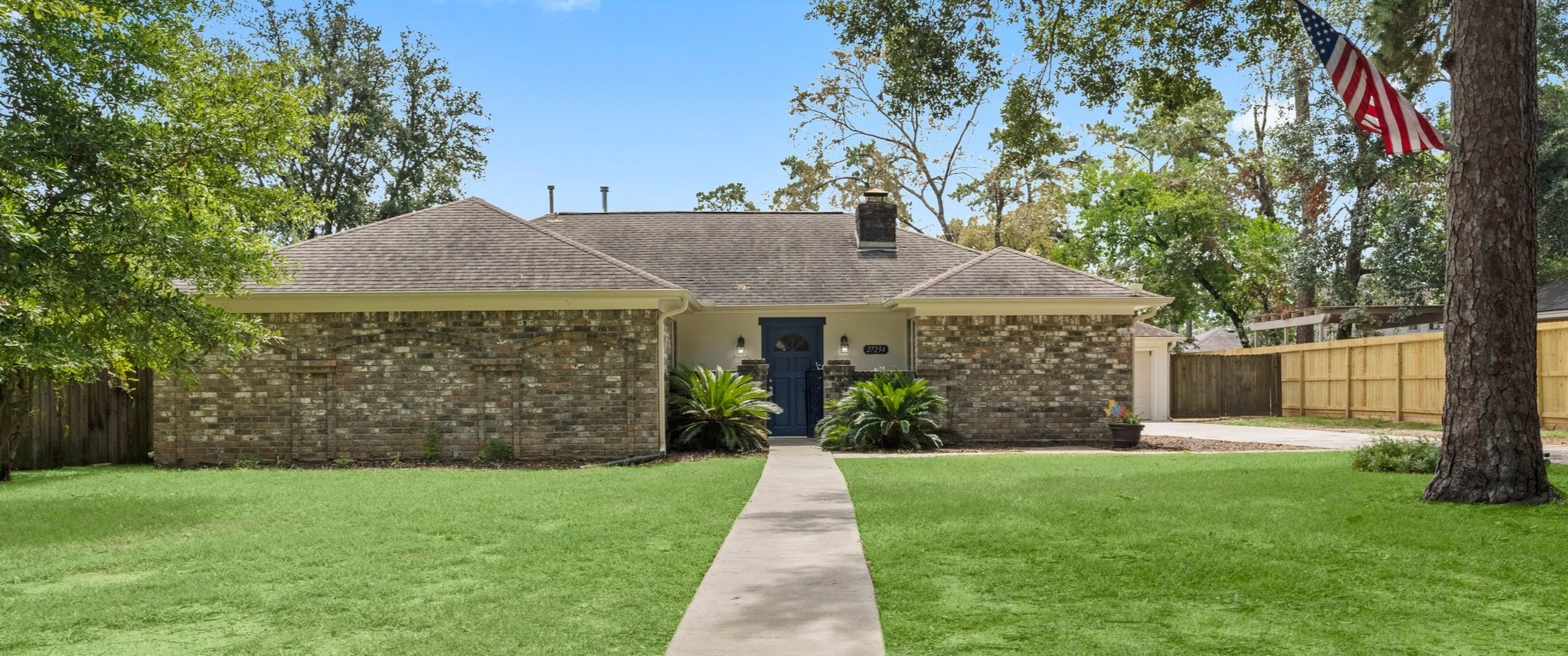 27234 Wells Lane Conroe, TX 77385 - Photo 1 of 15 a front view of house with a garden
