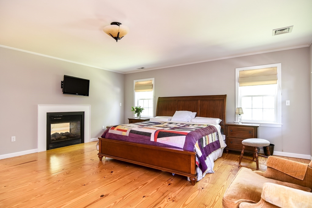 33 Grove Street Framingham, MA 01701 - Photo 20 of 33 a bedroom with a bed and a fireplace