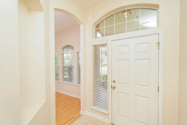 a view of a grassy field with trees in the background
