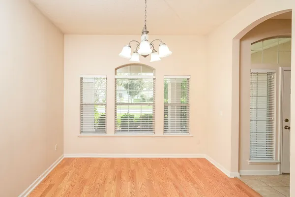 a view of an empty room with large windows