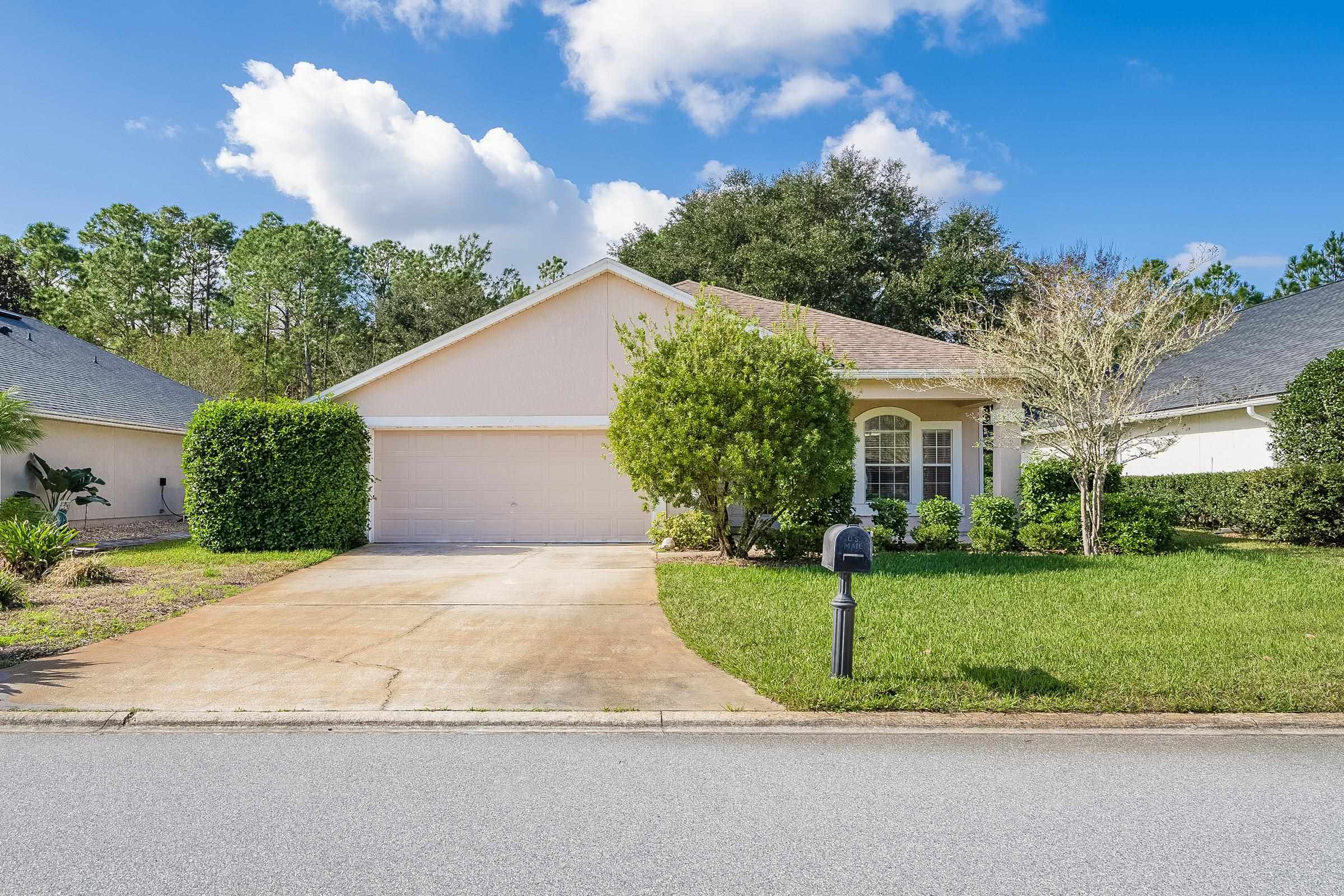 1525 Remington Way St. Augustine, FL 32084 - Photo 2 of 51 a view of a white house with a yard and plants