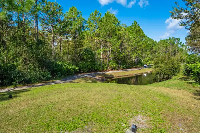 a front view of house with yard and trees
