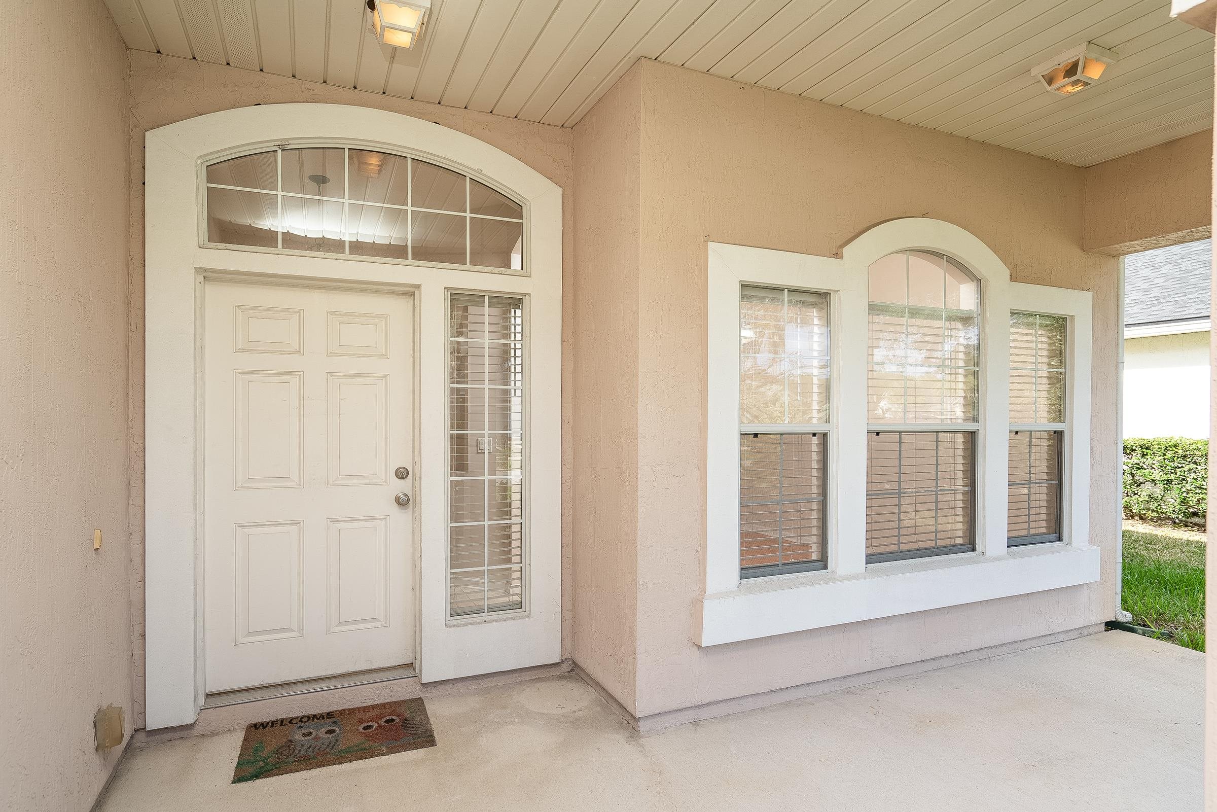 1525 Remington Way St. Augustine, FL 32084 - Photo 7 of 51 a front view of a house with a glass door