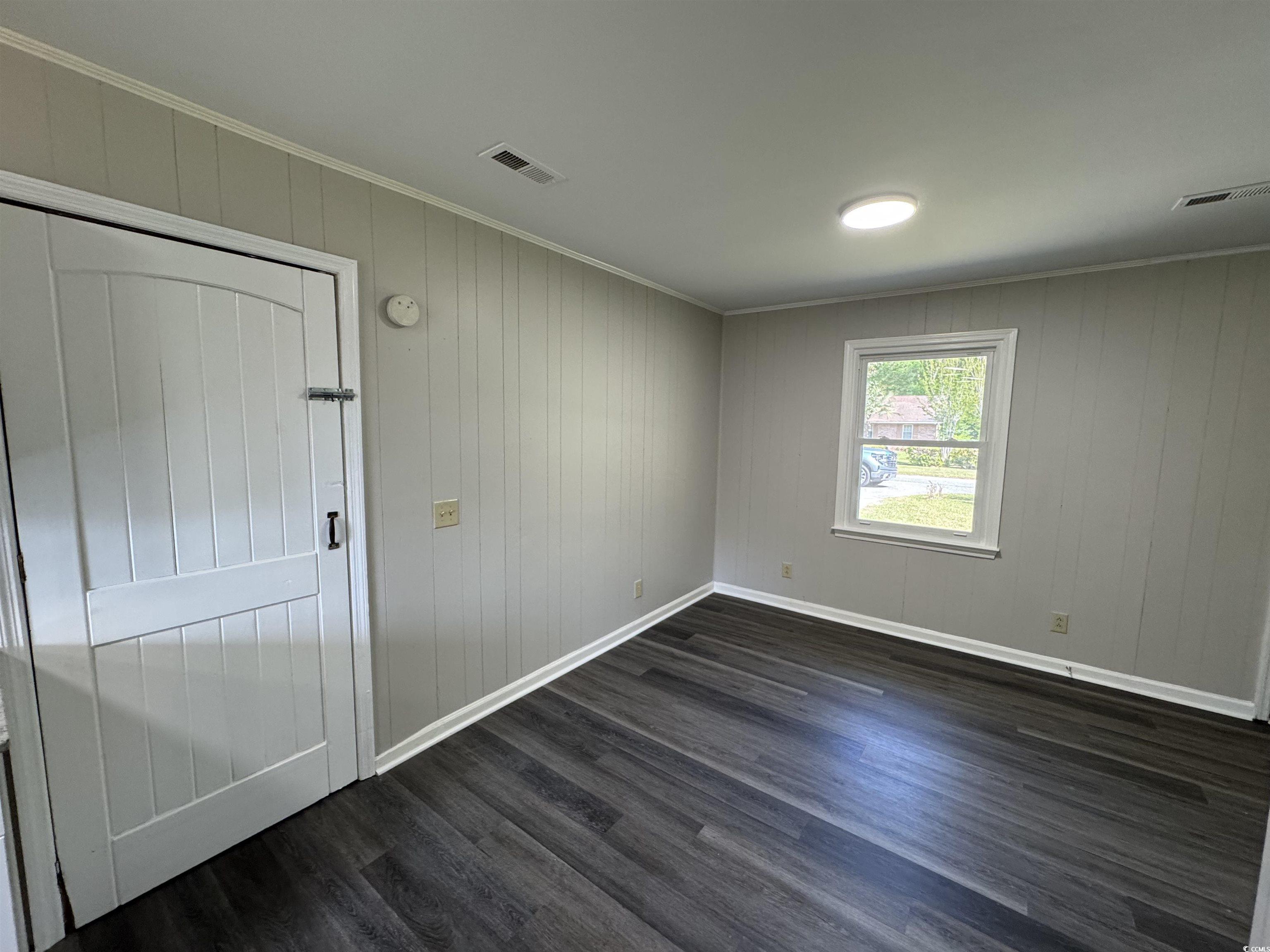 333 Whites Creek Road Georgetown, SC 29440 - Photo 6 of 13 Empty room featuring dark wood-style floors, crown