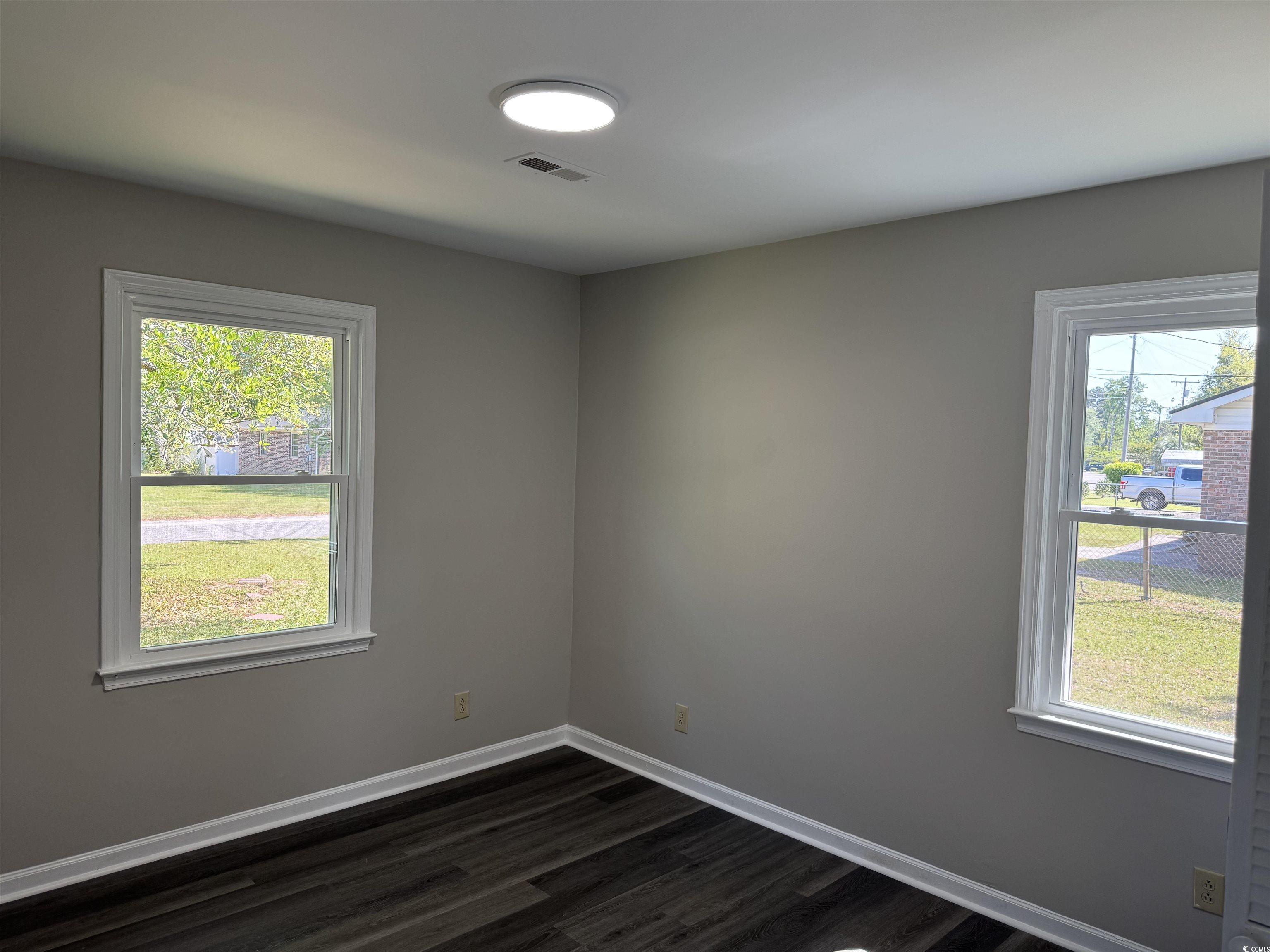 333 Whites Creek Road Georgetown, SC 29440 - Photo 7 of 13 Unfurnished room featuring visible vents, dark woo