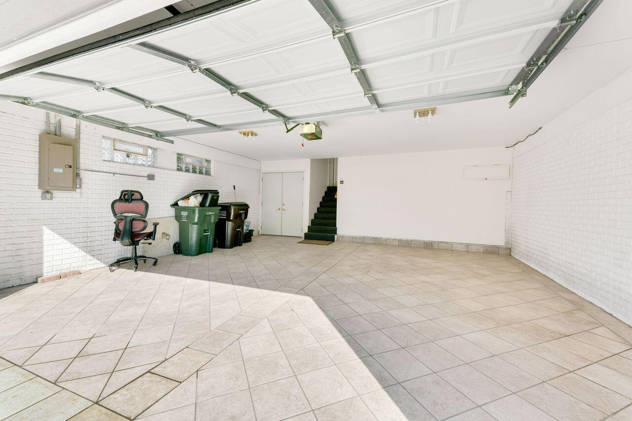 3030 South 130th Street New Berlin, WI 53151 - Photo 17 of 17 Attached garage featuring tiled flooring and ample room for storage.