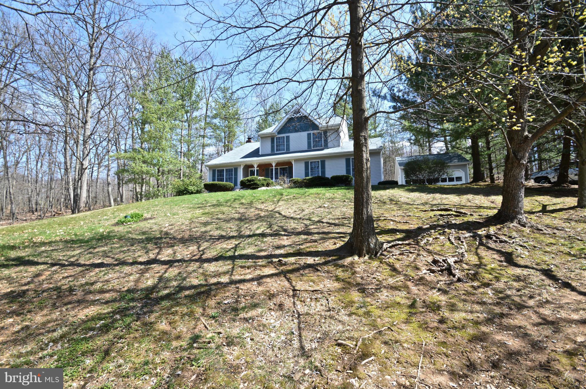 3800 Roop Road New Windsor, MD 21776 - Photo 2 of 29 a house with trees in front of it