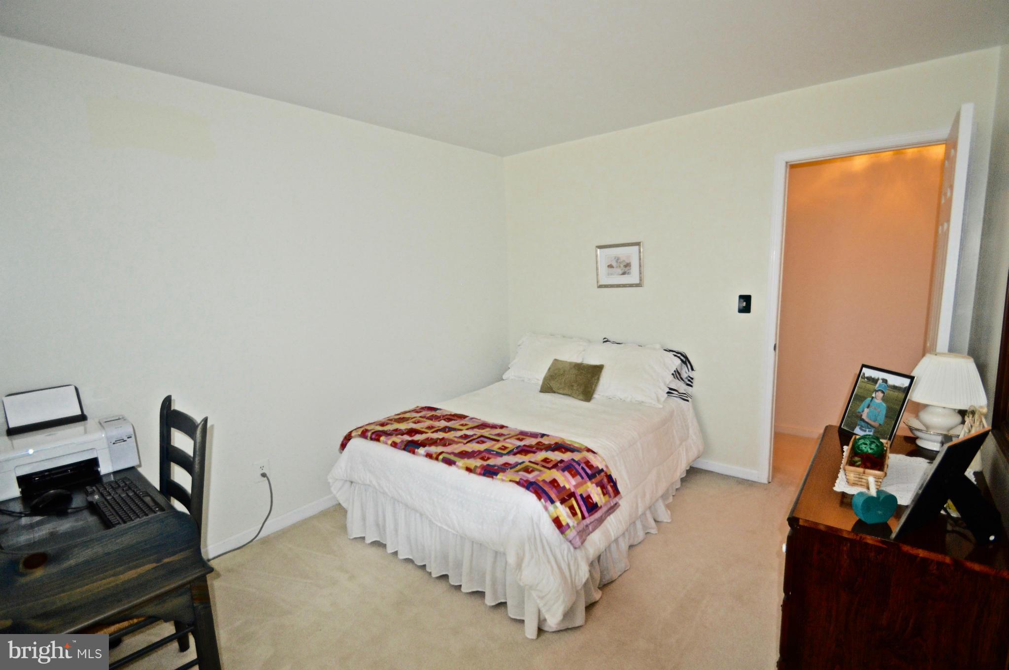 3800 Roop Road New Windsor, MD 21776 - Photo 19 of 29 a bedroom with a bed and wooden floor