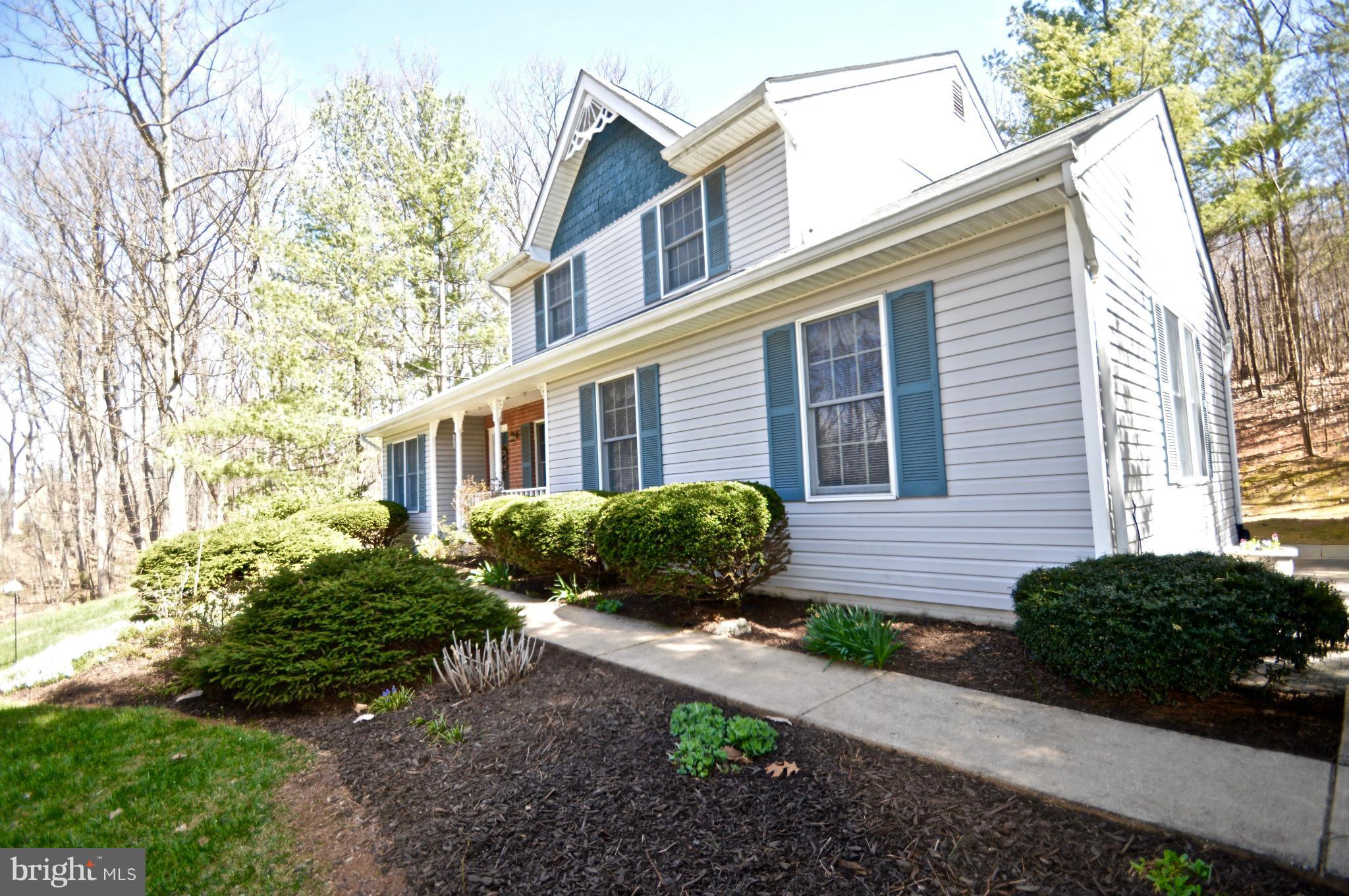 3800 Roop Road New Windsor, MD 21776 - Photo 3 of 29 a front view of a house with a yard and outdoor seating
