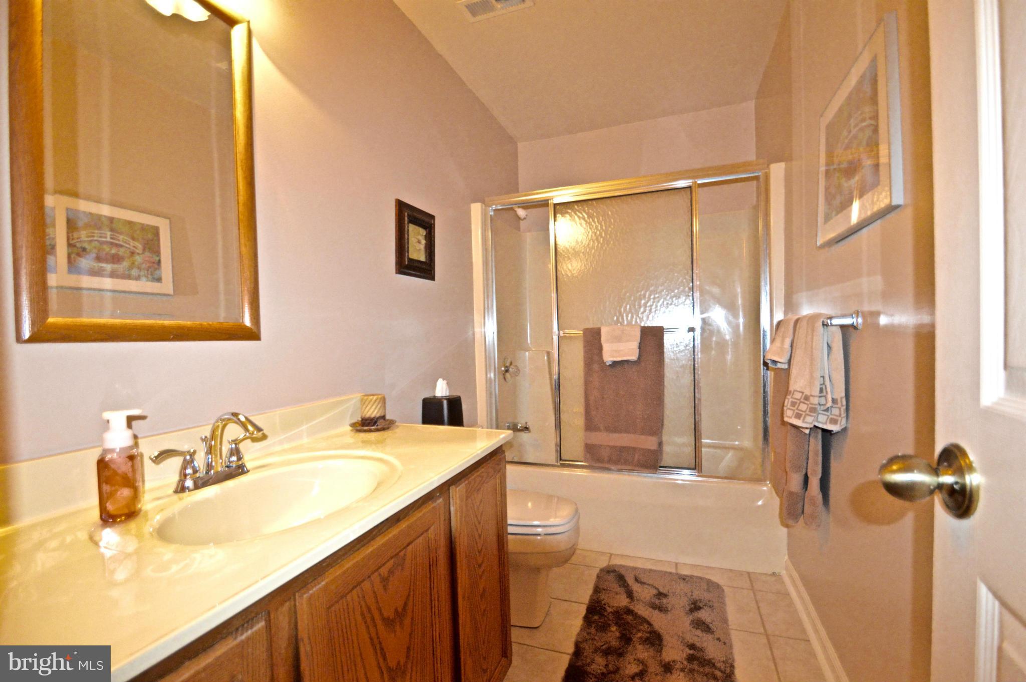3800 Roop Road New Windsor, MD 21776 - Photo 21 of 29 a bathroom with a granite countertop sink and a mirror