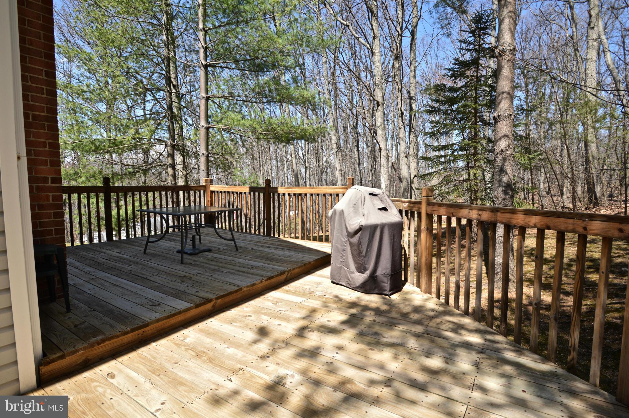 3800 Roop Road New Windsor, MD 21776 - Photo 29 of 29 a view of a deck with wooden floor and fence with a bench