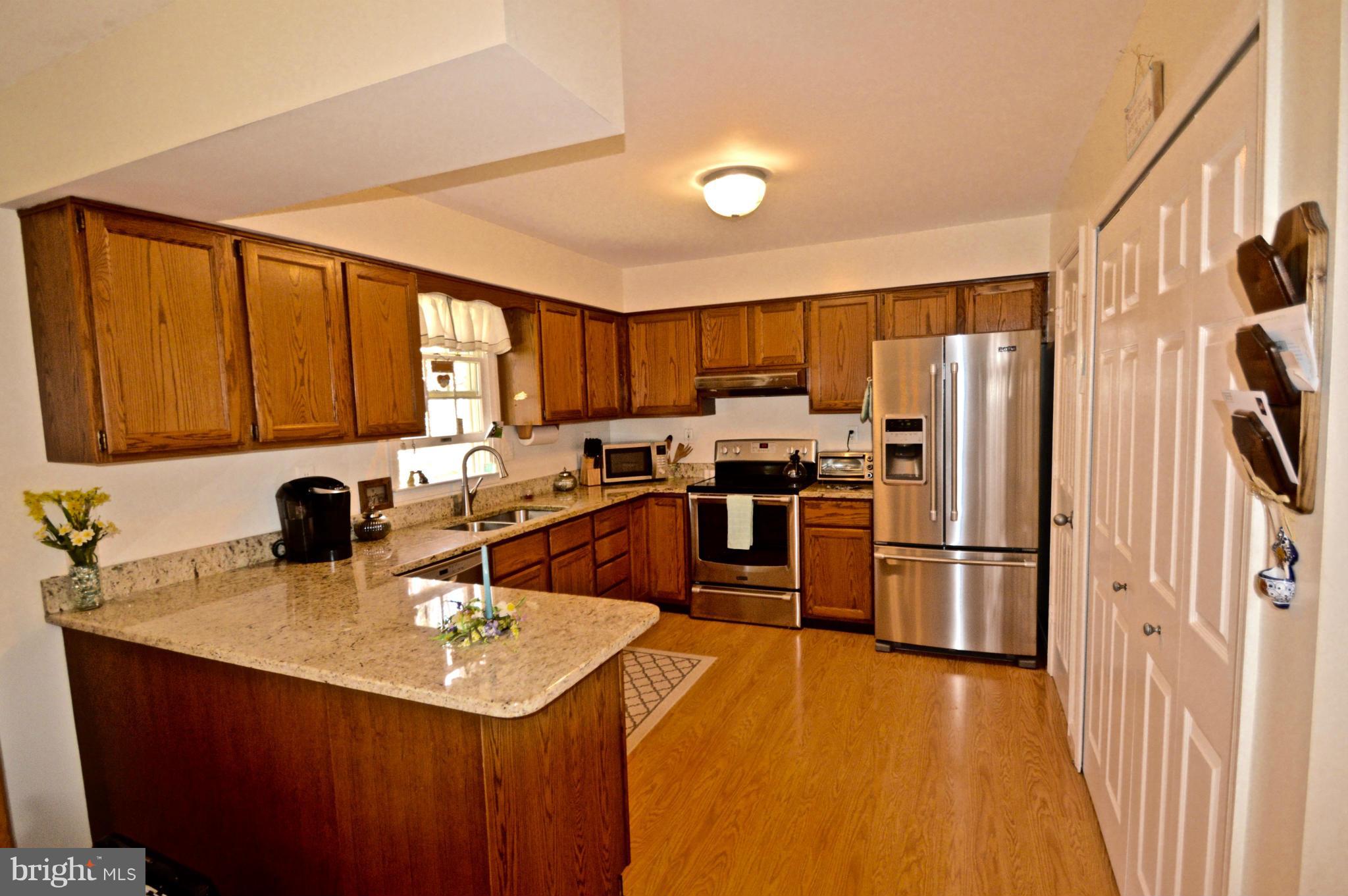 3800 Roop Road New Windsor, MD 21776 - Photo 5 of 29 a kitchen with kitchen island a sink appliances and cabinets