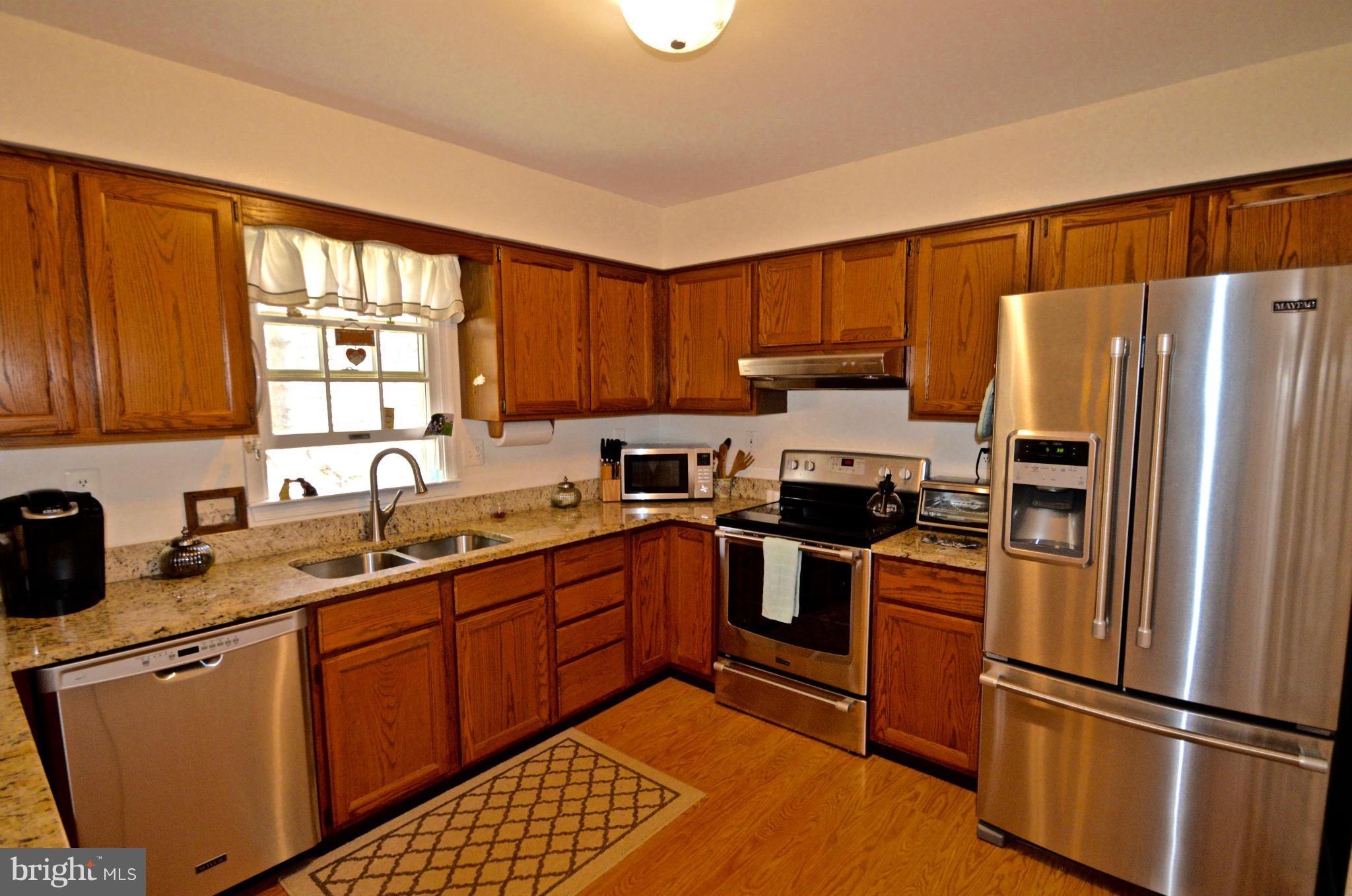 3800 Roop Road New Windsor, MD 21776 - Photo 6 of 29 a kitchen with stainless steel appliances granite countertop a refrigerator stove top oven and sink