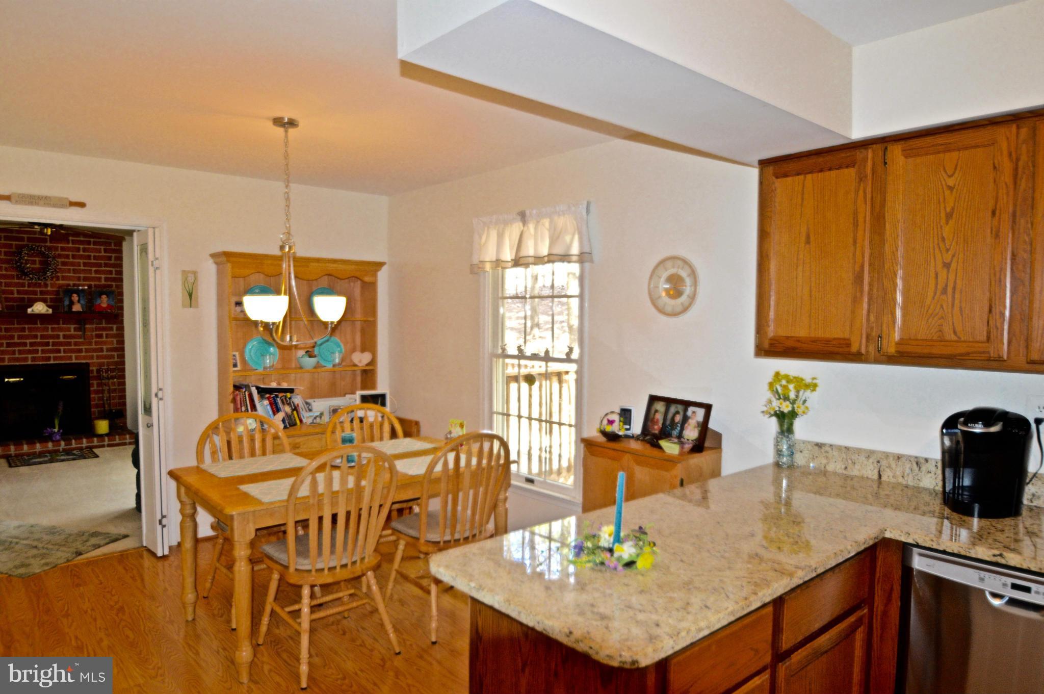 3800 Roop Road New Windsor, MD 21776 - Photo 8 of 29 a kitchen with a table chairs and chandelier