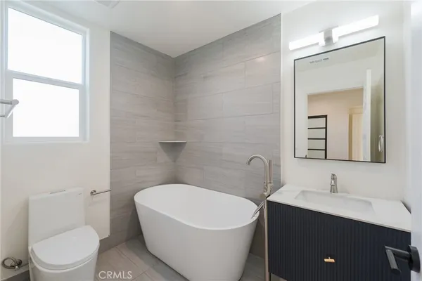 a bathroom with a sink toilet and mirror