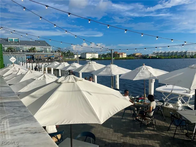 a dining room with lots of wooden furniture and a chandelier