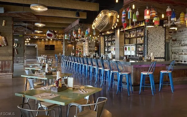 a dining room with furniture and a floor to ceiling window