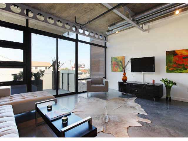 1401 Eva Street, Unit 305 Austin, TX 78704 - Photo 1 of 1 a living room with furniture and a flat screen tv