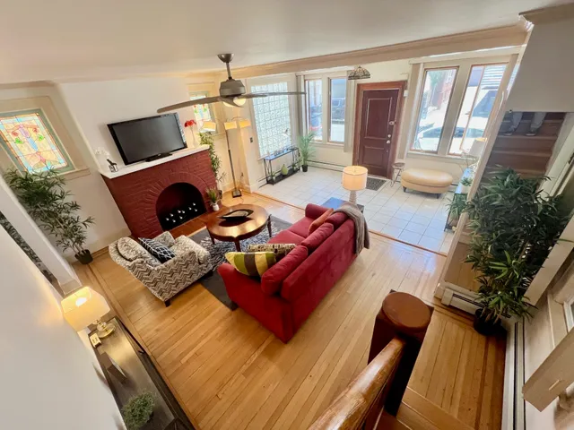 a living room with furniture a flat screen tv and a fireplace