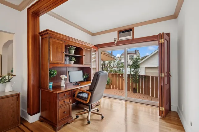 a workspace room with furniture and a window