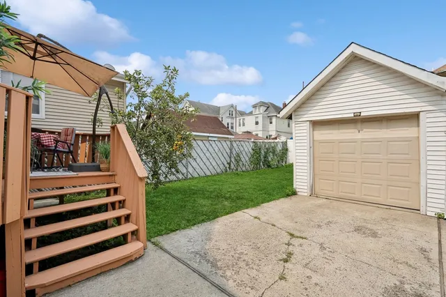 a view of backyard of house and wooden stairs