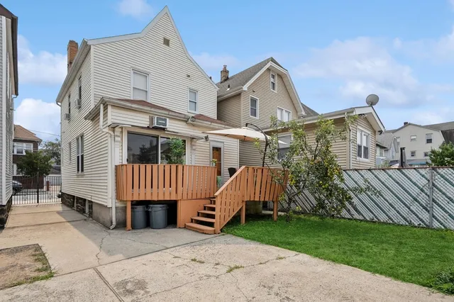 a view of house with garden and deck
