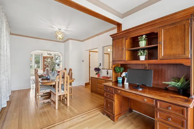 a view of a dining room with furniture and wooden floor