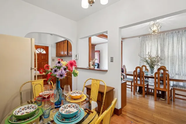 a dining room with furniture and wooden floor