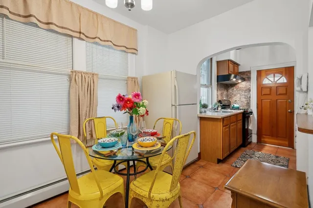 a dining room with furniture and window