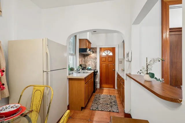a kitchen with stainless steel appliances granite countertop a refrigerator and a sink