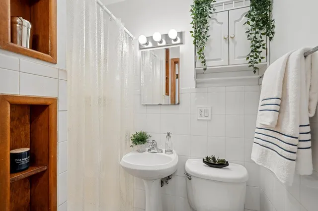 a bathroom with a sink toilet and mirror