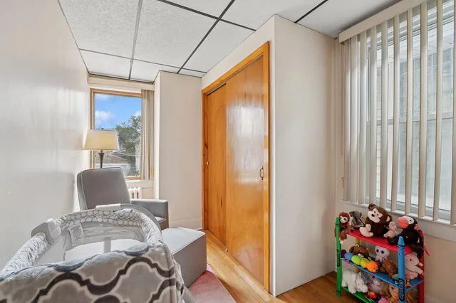 a bedroom with furniture and a window