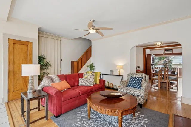 a living room with furniture and wooden floor