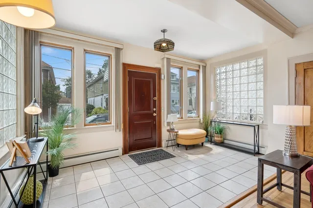 a bedroom with a bed and large window with chair